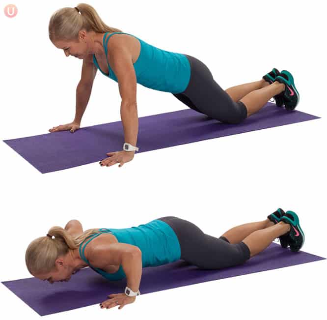 Chris Freytag doing a modified push-up from her knees connected  a purple yoga mat. 