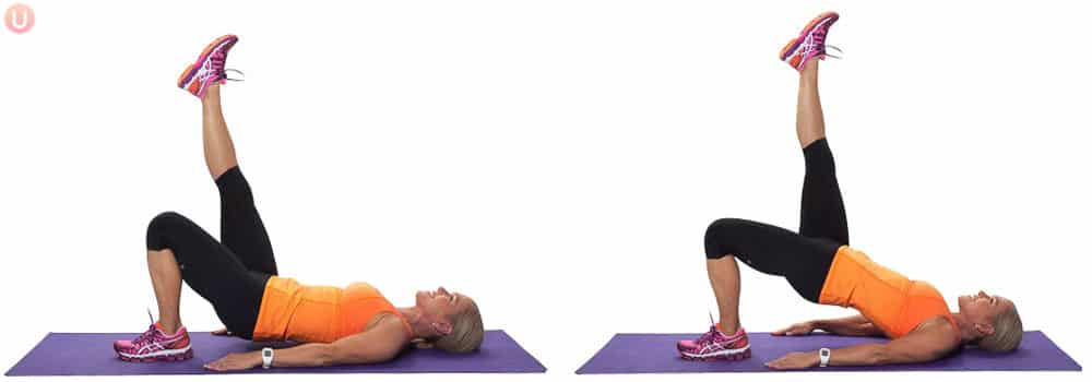 Chris Freytag doing a single leg glute bridge on a purple yoga mat.