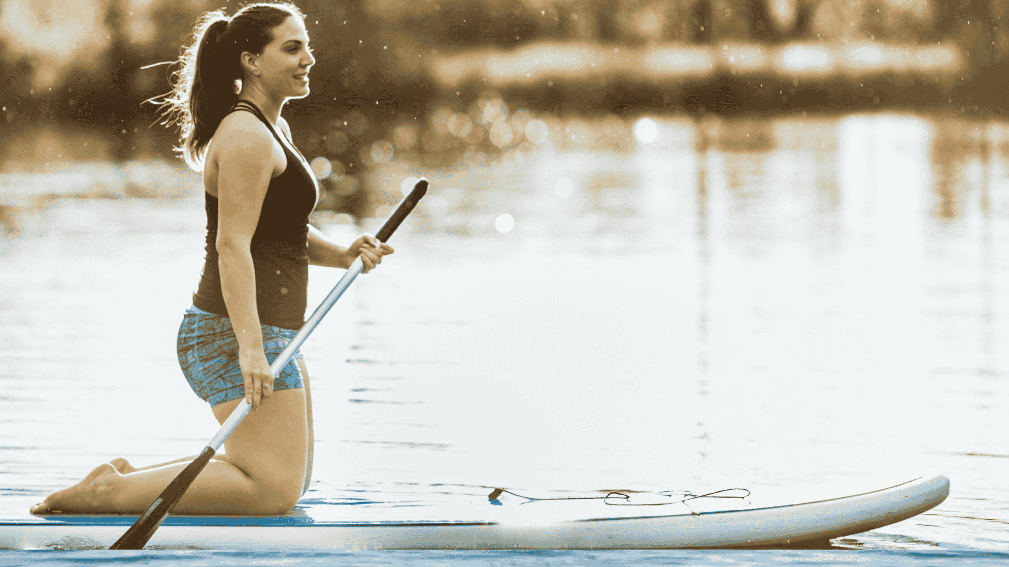 woman kneeling on paddleboard