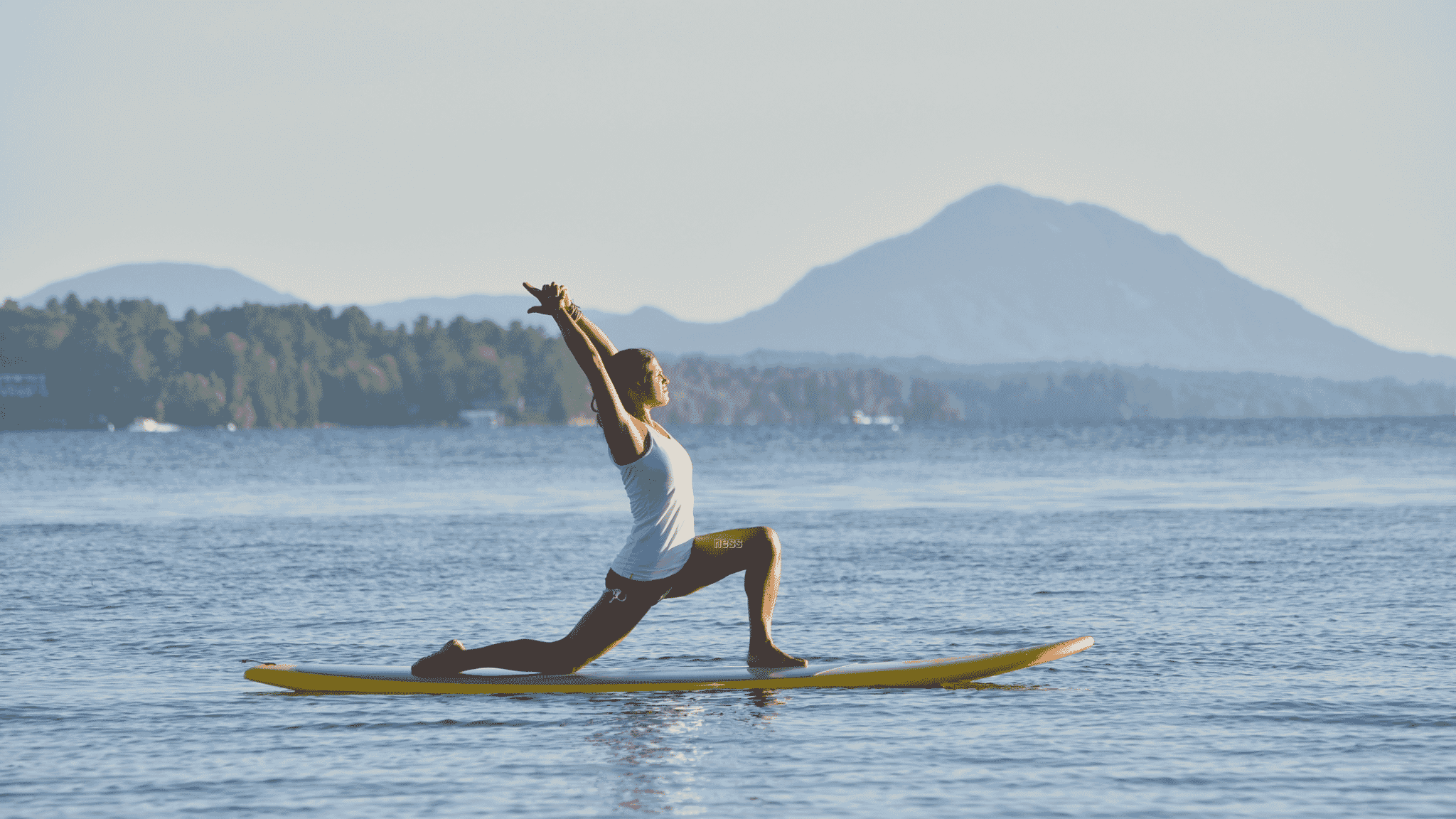 warrior yoga position on paddleboard