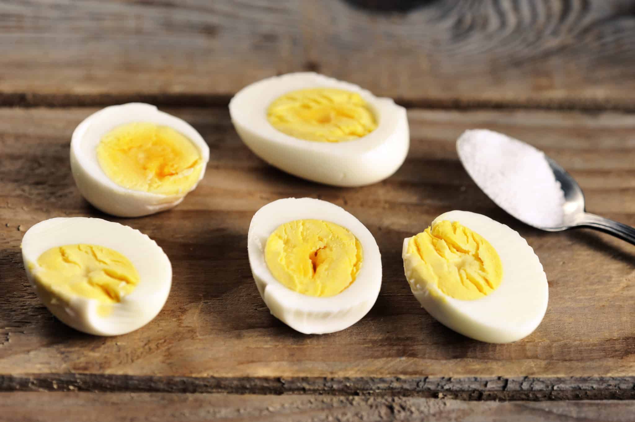 Hard boiled eggs cut in half on wooden table