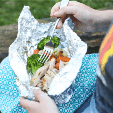 Chicken, broccoli, carrots and cauliflower in a packet of tin foil