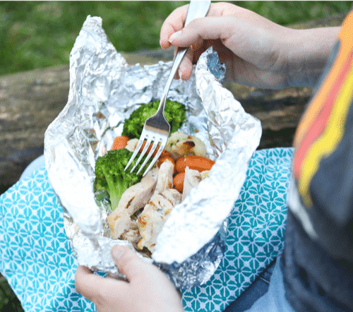 Chicken, broccoli, carrots and cauliflower in a packet of tin foil