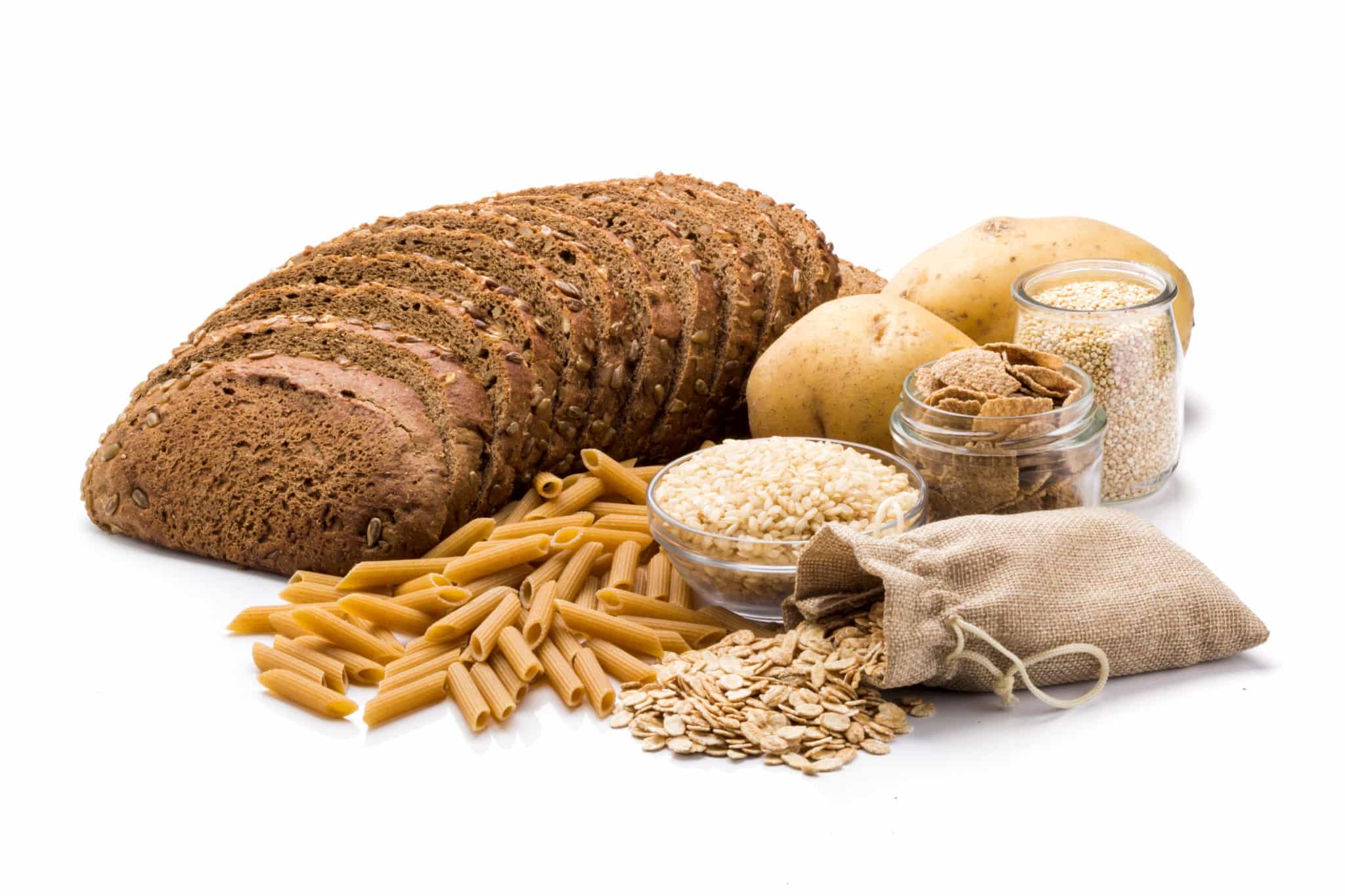 Whole grain bread, pasta, rice, potatoes and bran on white showing carbohydrate options