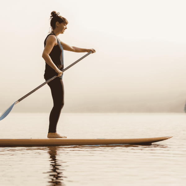 woman paddleboarding on foggy morning