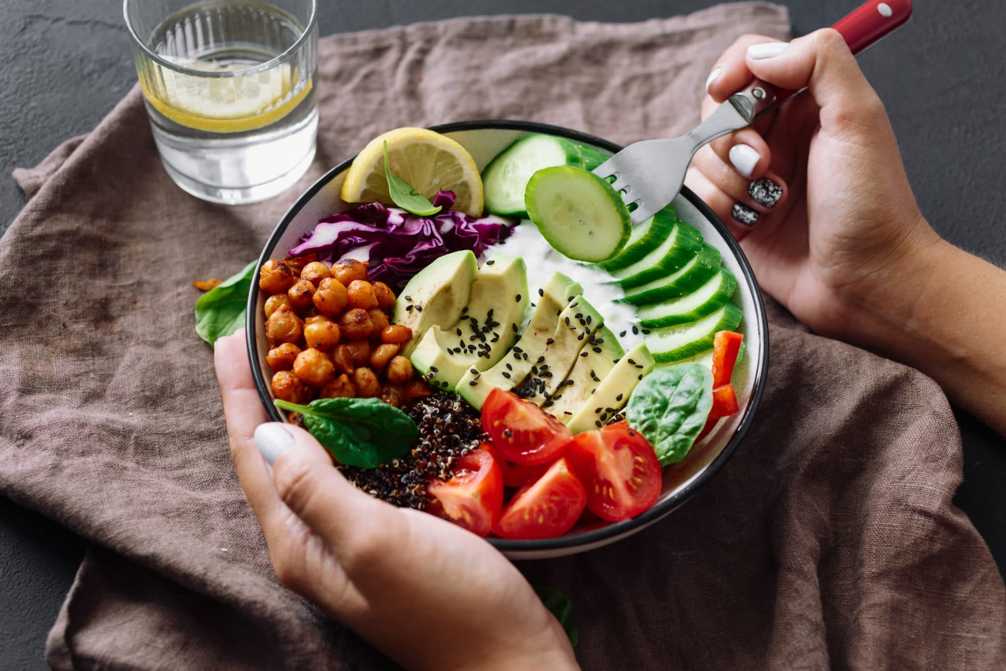 Healthy salad with avocado, chickpeas, tomatoes, cucumbers, and purple cabbage