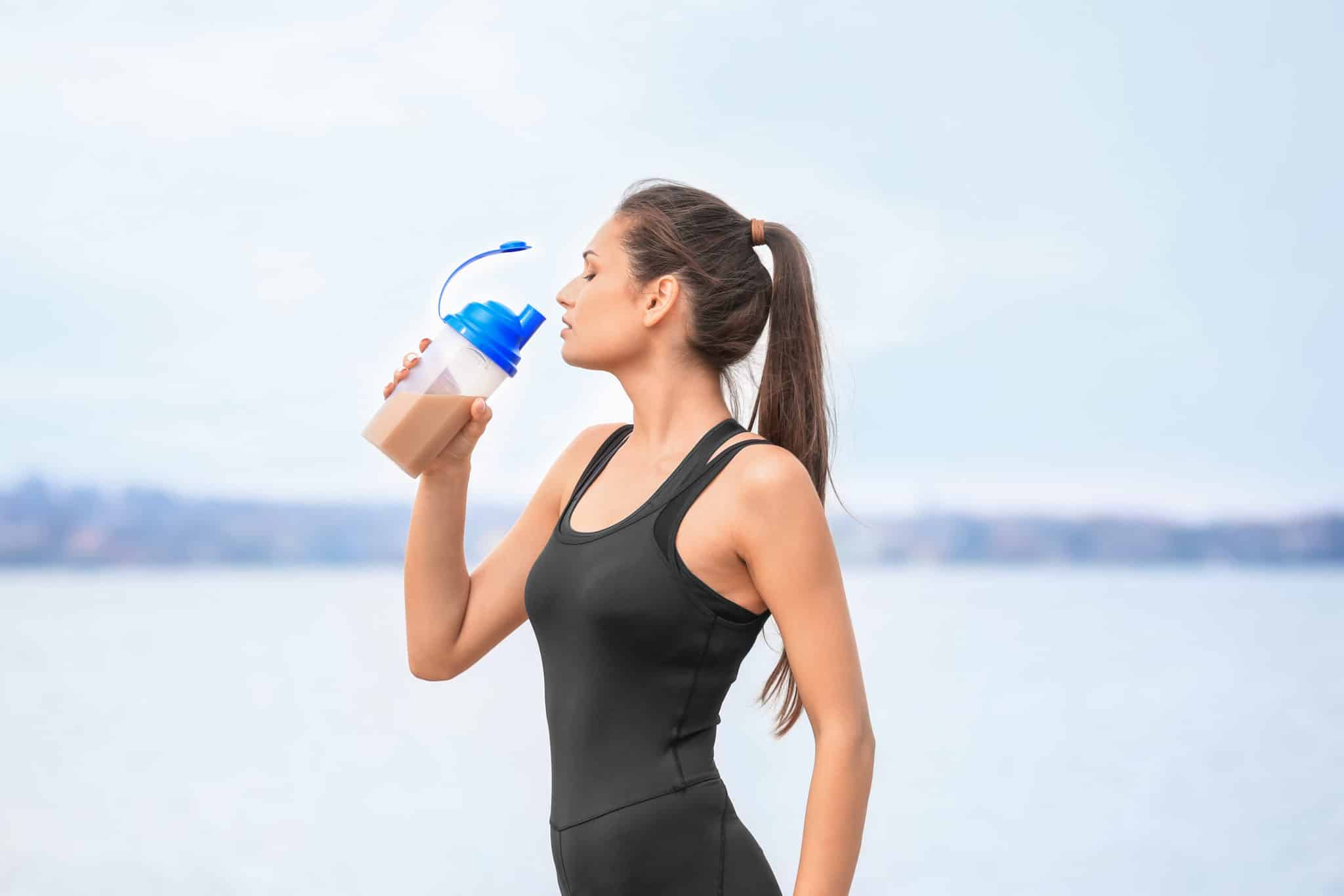 Fitness woman drinking protein shake