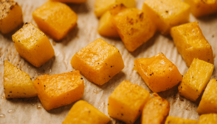Roasted butternut squash on a parchment lined sheet pan