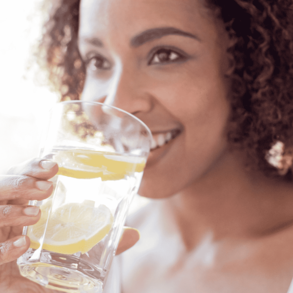 woman drinking water from a cup