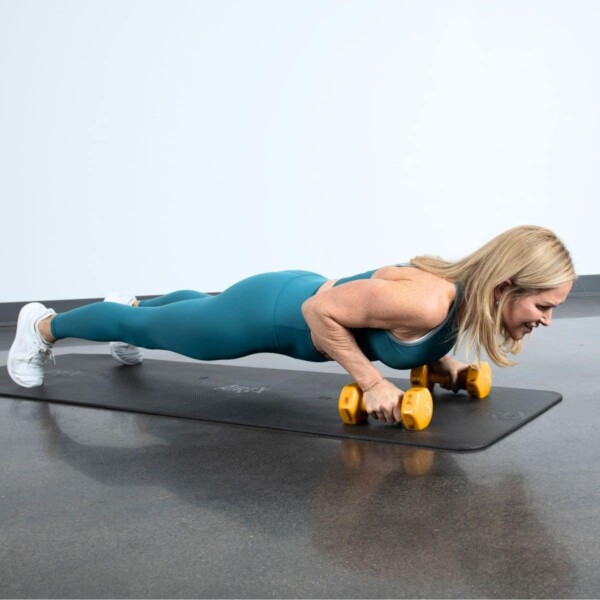 woman doing back fat exercises with dumbbells