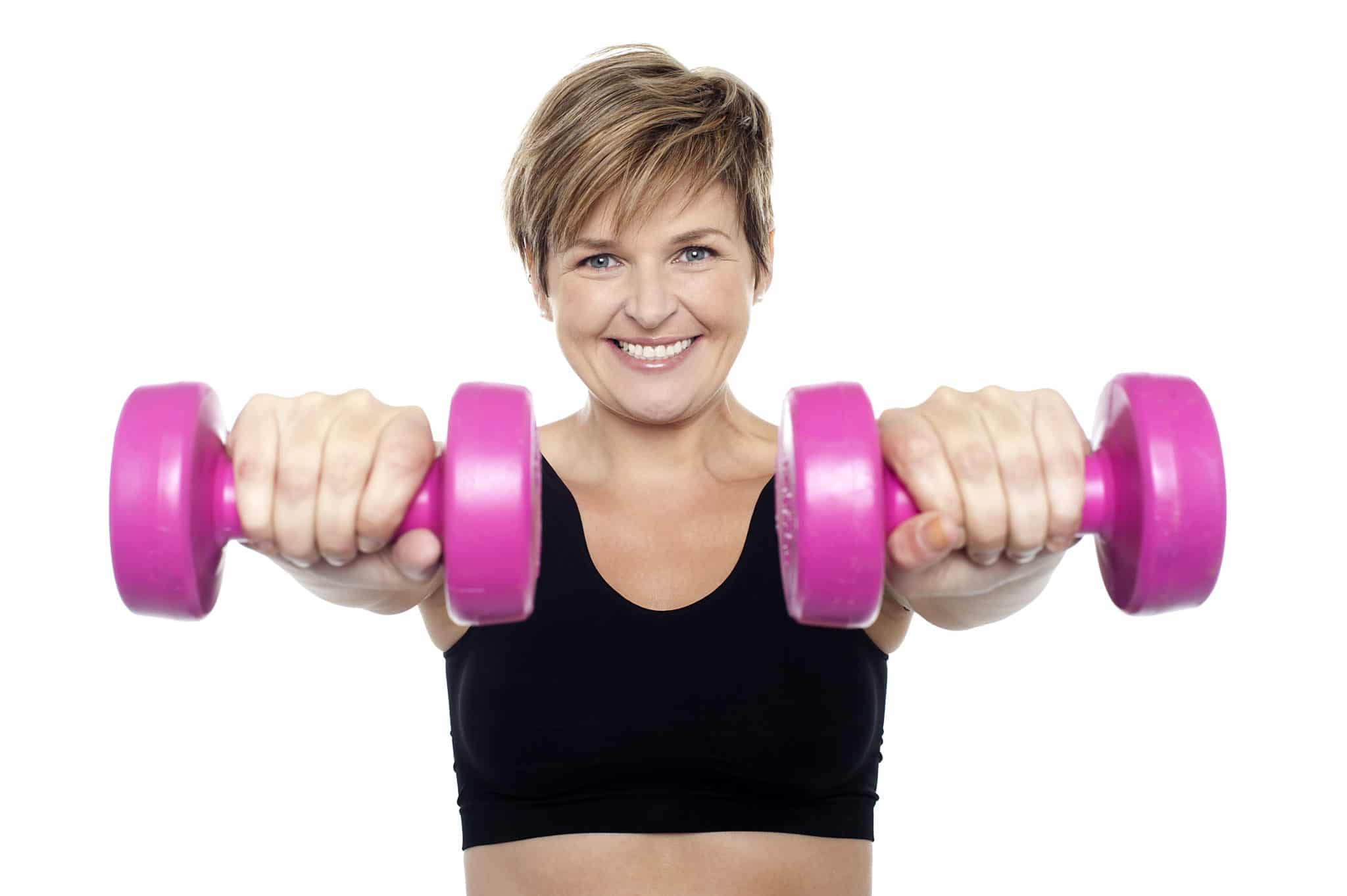 Woman with pink dumbbells demonstrating an at-home dumbbell chest workout