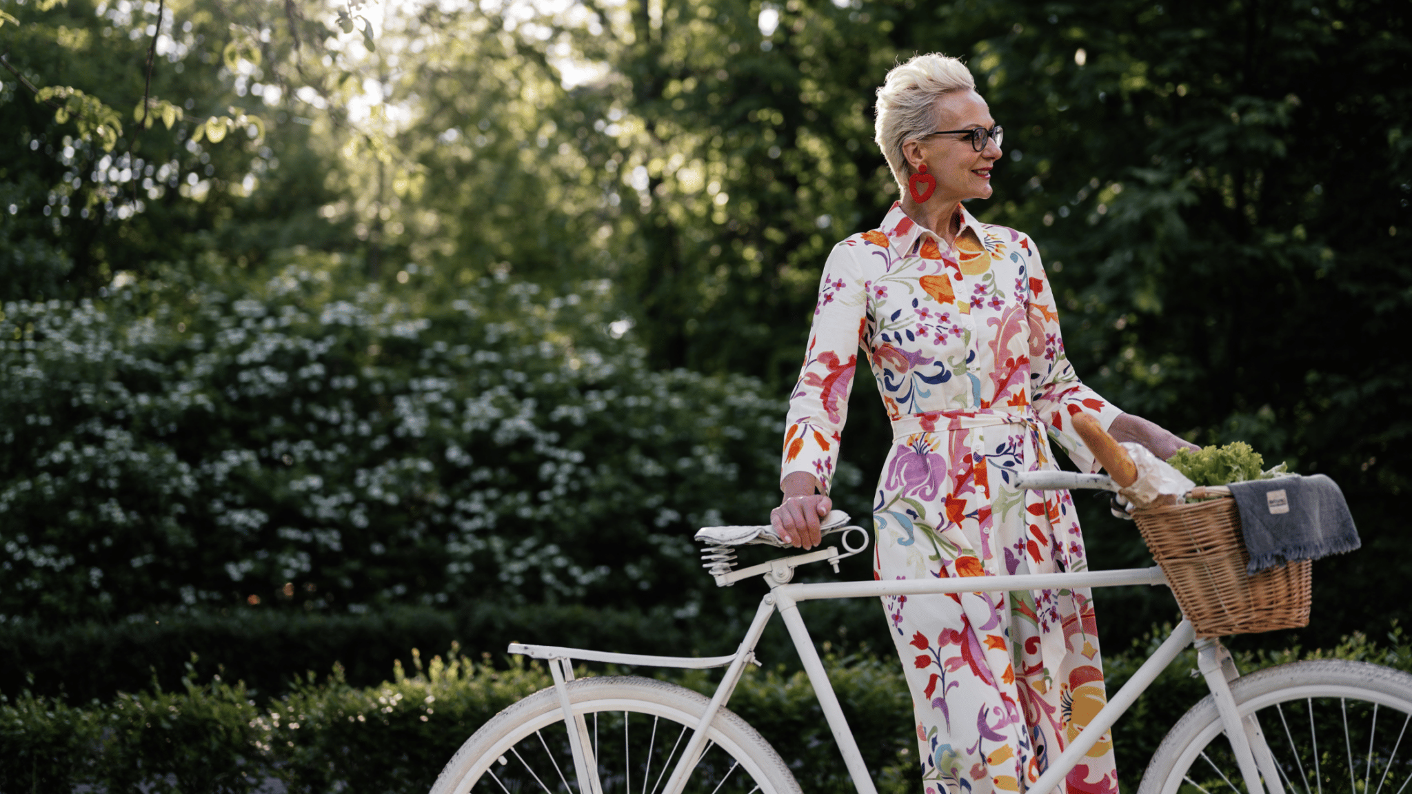 older woman in dress on a bike