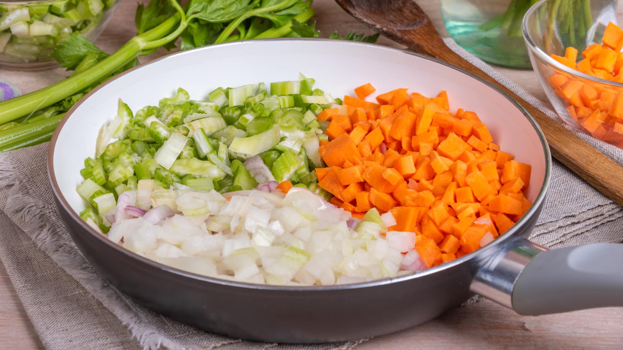 Chopped onions, carrots, celery in a bowl for soup