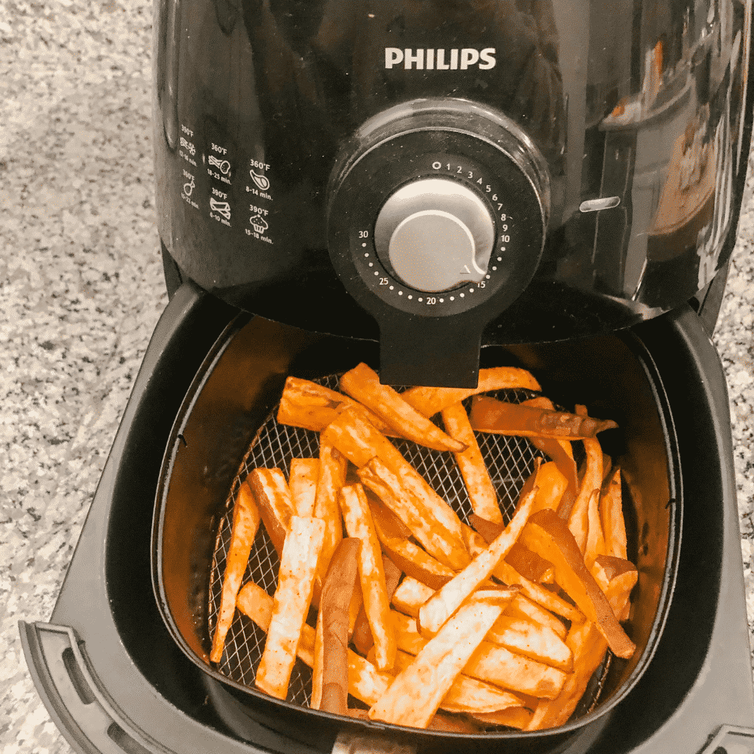 Black Philips Air Freyer cooking sweet potato fries.