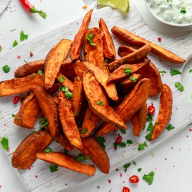 Sweet potato fries on white plate that were cooked in the air fryer