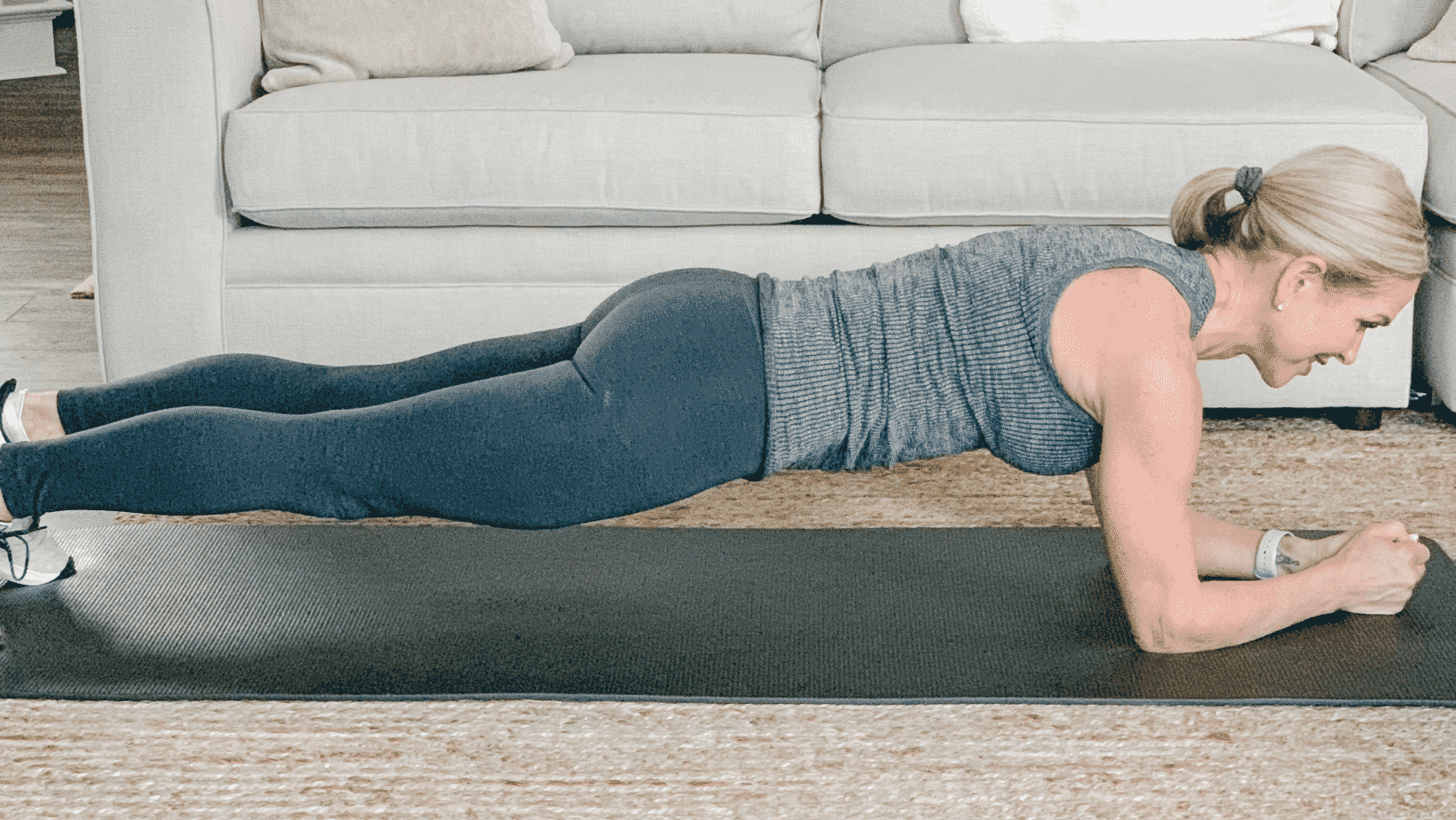 Chris Freytag doing a forearm plank on a black mat