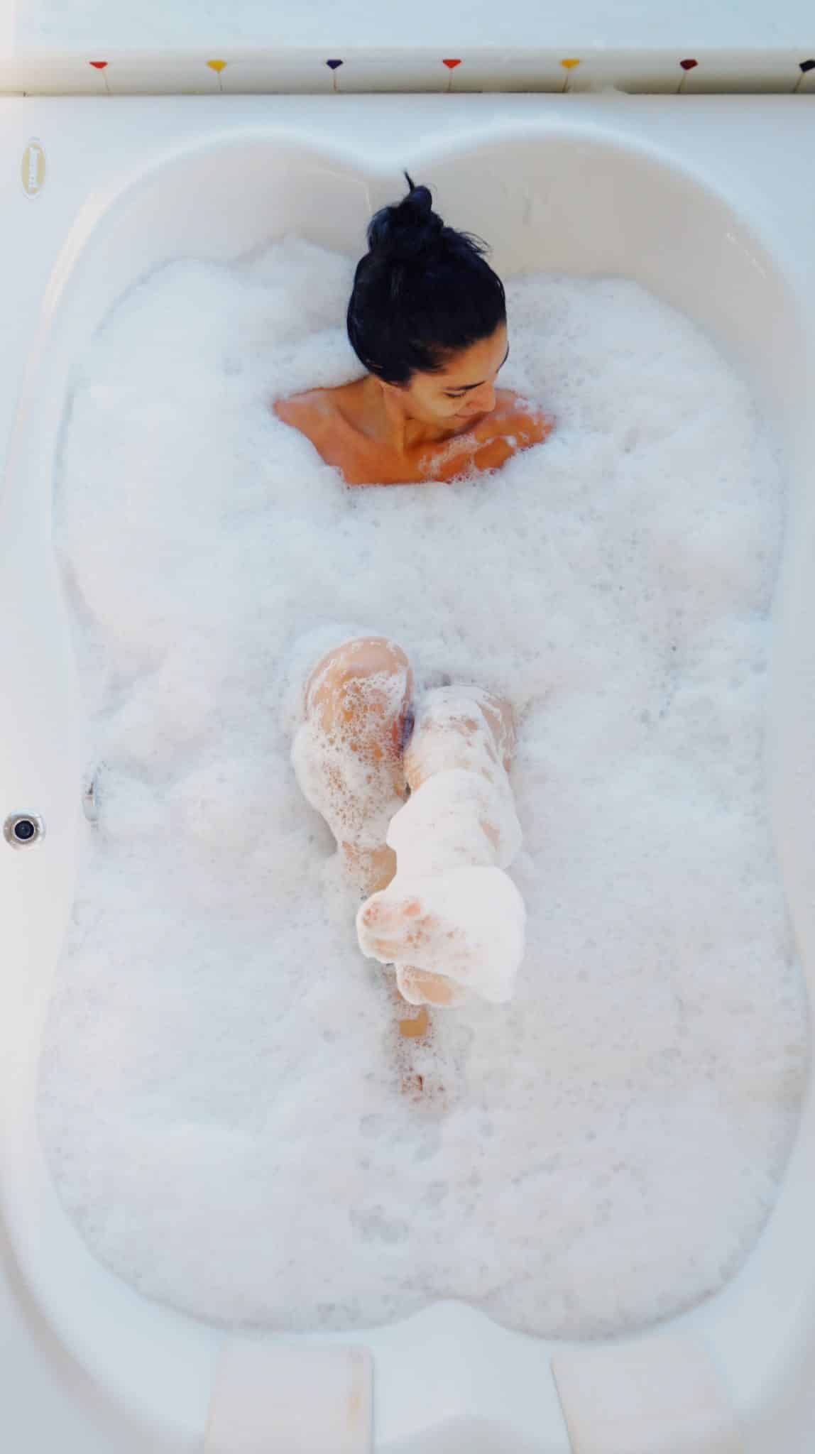 photo of woman in bubble bath
