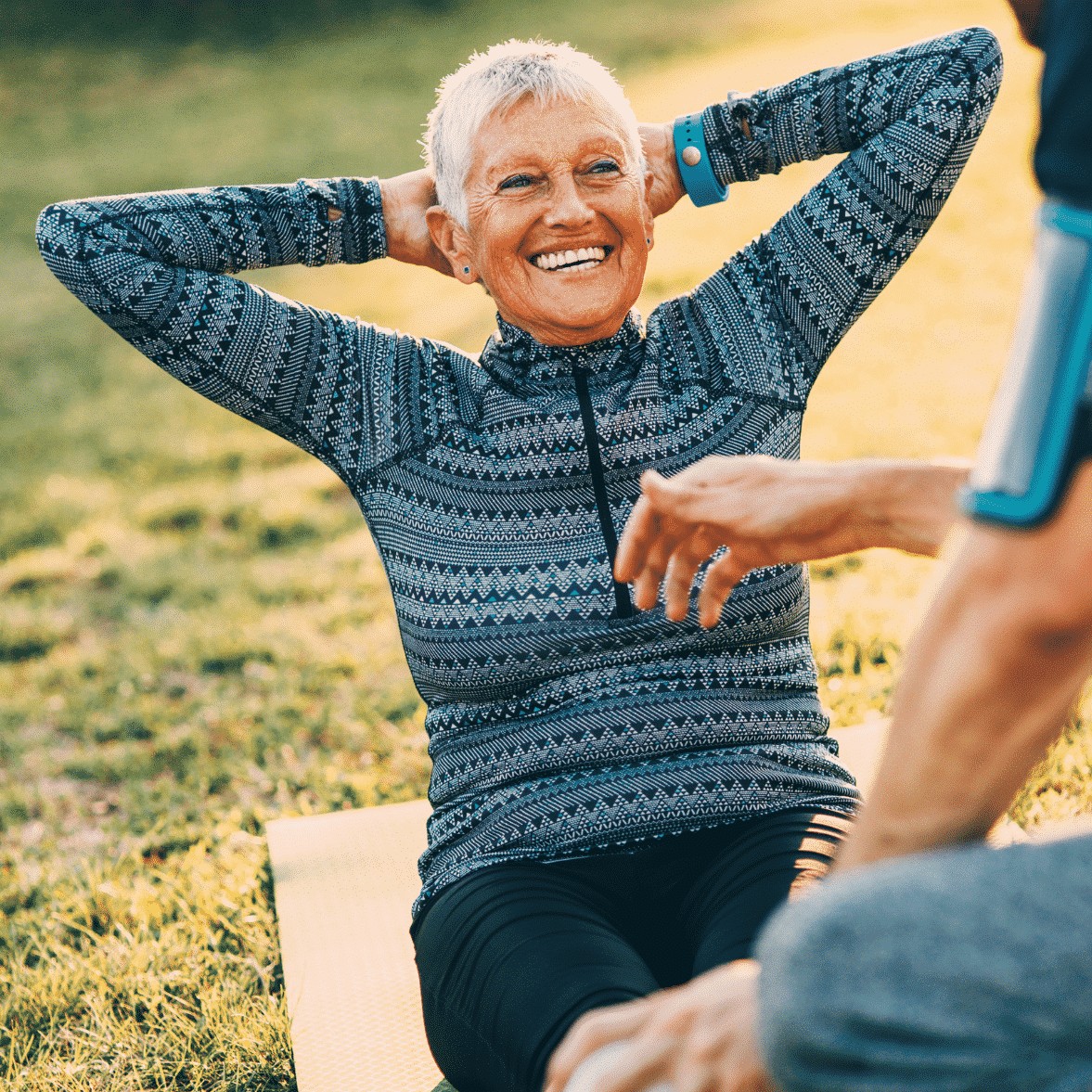 woman doing a crunch outside with a smile