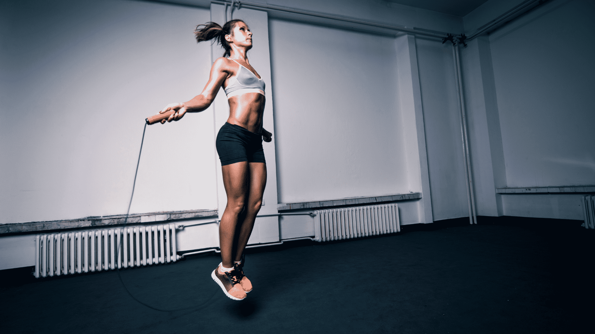 fit woman inside jumping rope
