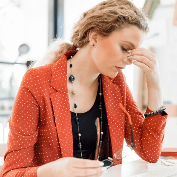 woman at desk looking tired