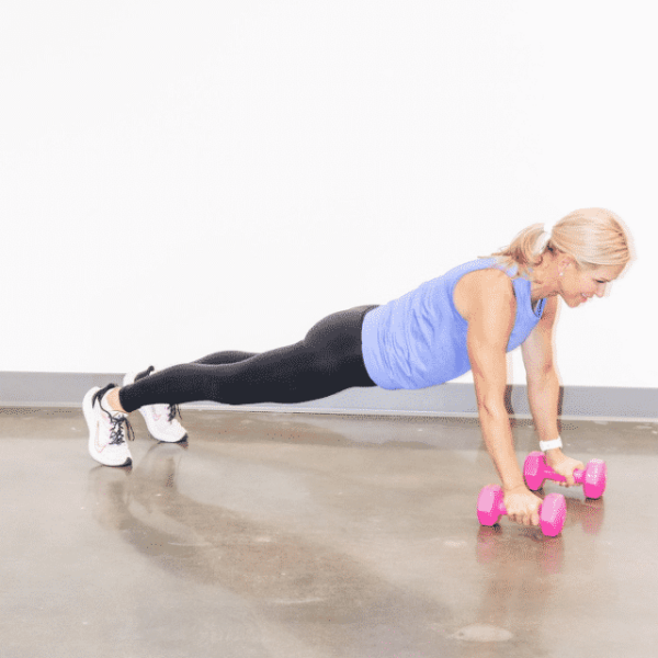 Chris Freytag holding a dumbbell high plank hold.