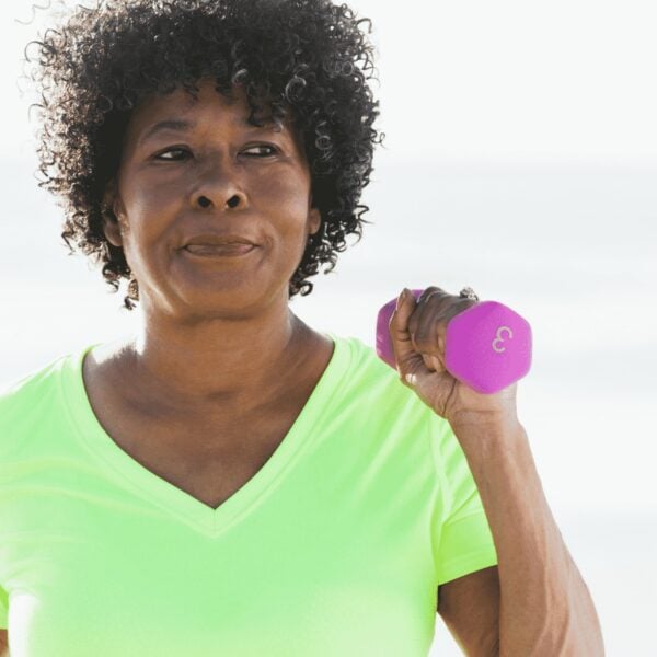 Middle aged woman holding a dumbbell for exercise equipment