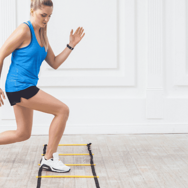 Women wearing blue tank top doing an agility ladder workout