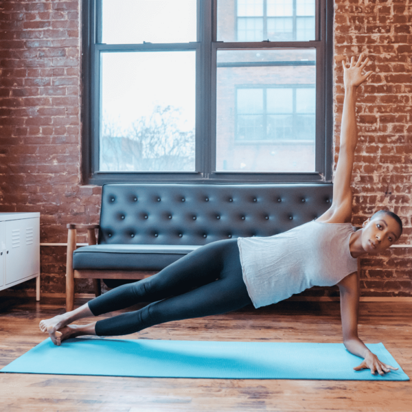 woman doing a side plank in a condo