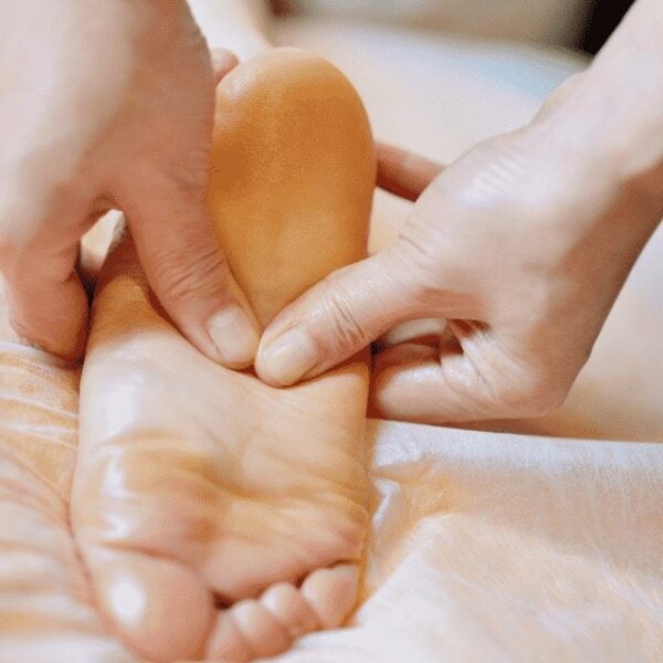 Rubbing a foot for plantar fasciitis relief.