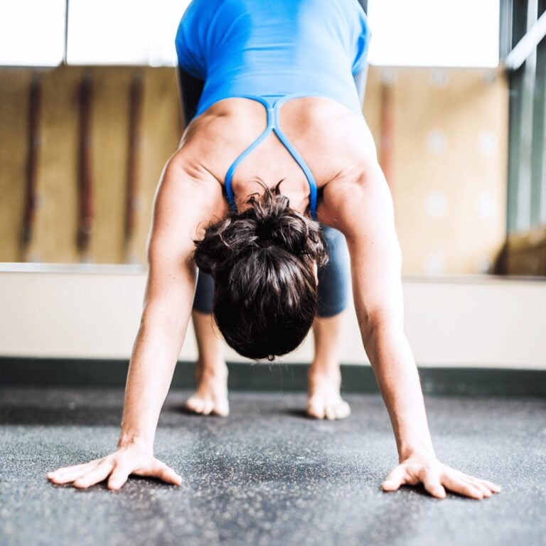 woman doing downward dog yoga stretche