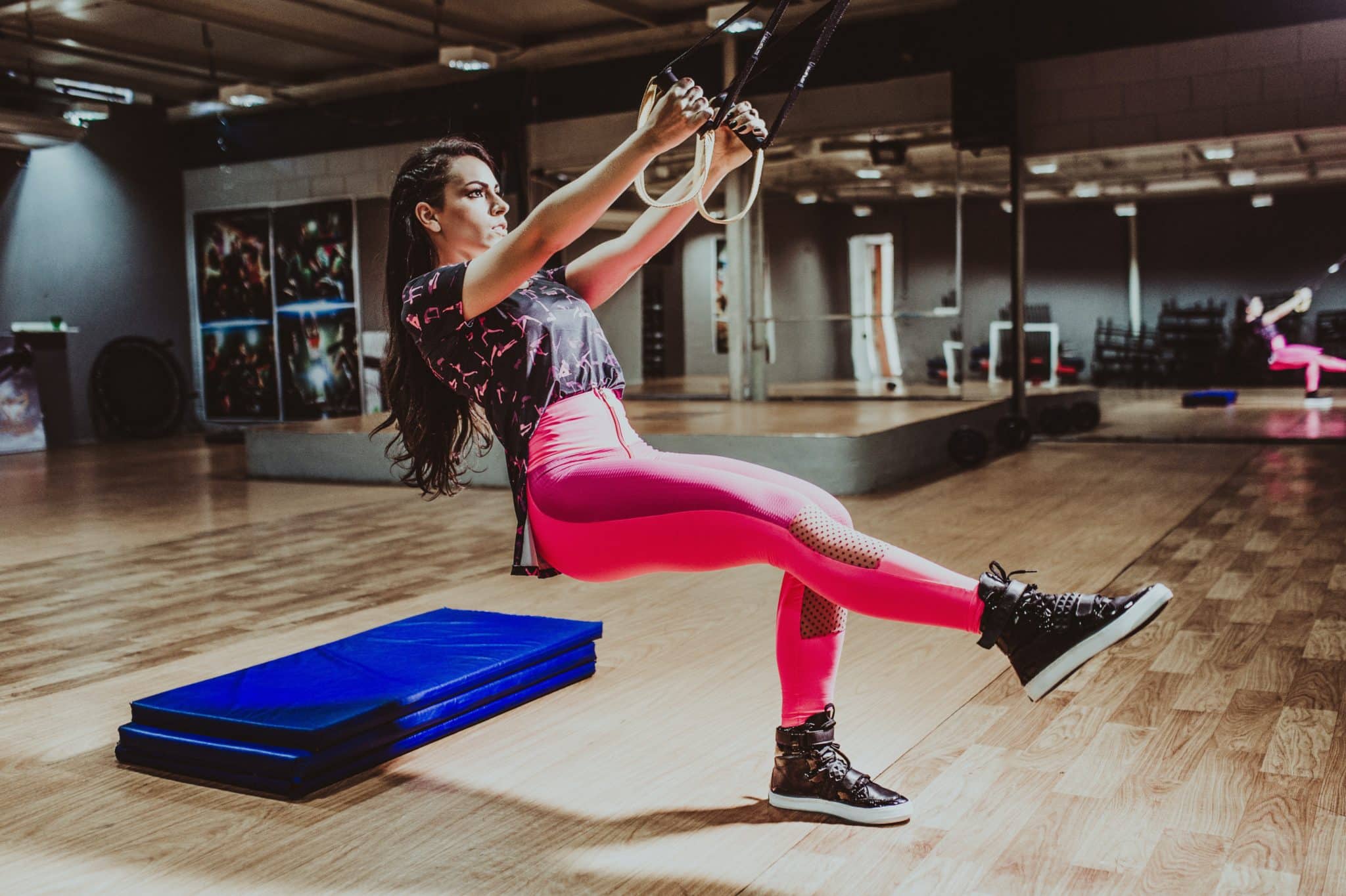 woman using suspension trainer for strength training