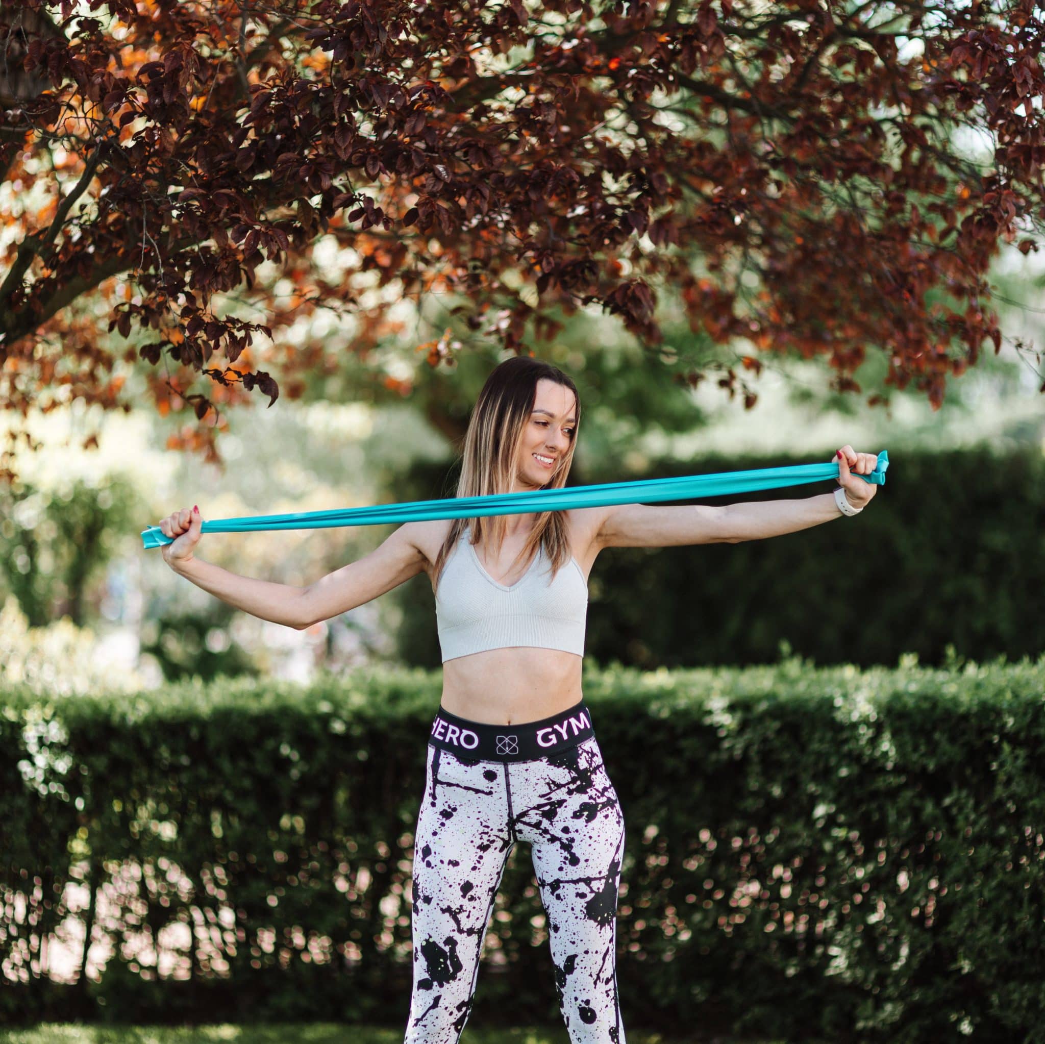 woman using resistance band outdoors