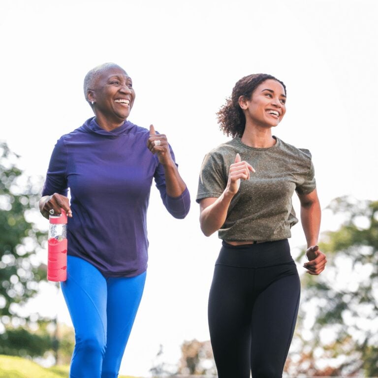 two woman power walking outside