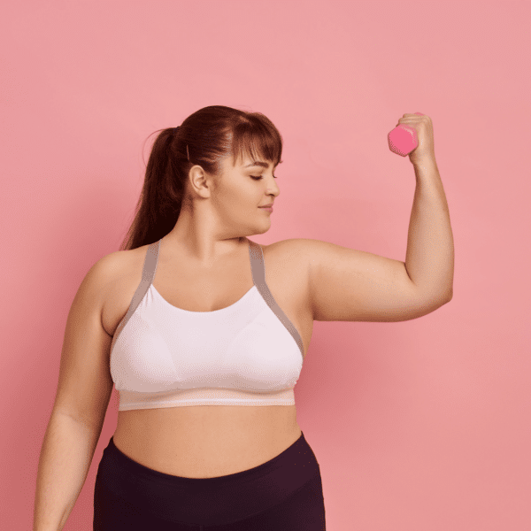 woman lifting weight with pink background