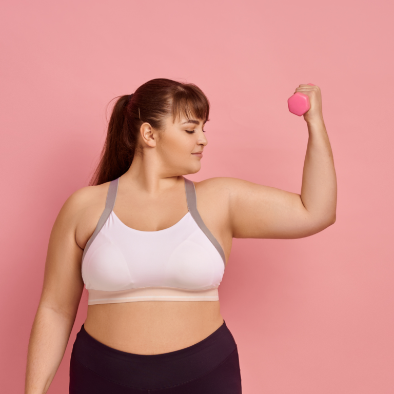 woman lifting weight with pink background