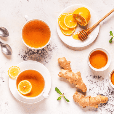 Lemon, ginger and mint tea on a white countertop to debloat