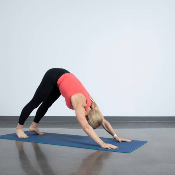 woman doing yoga poses for back pain downward dog