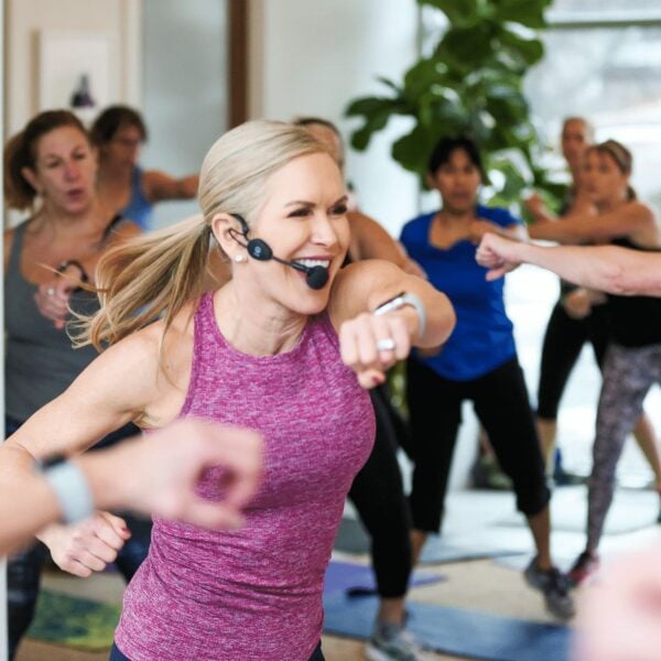 chris freytag in purple workout tank leading a workout