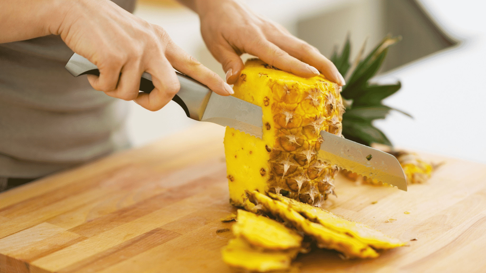 woman cutting fresh pineapple
