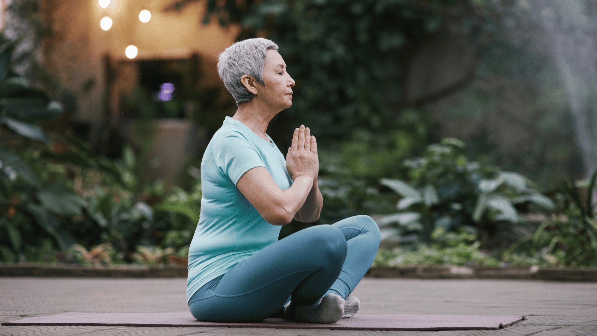 woman meditating in a garden