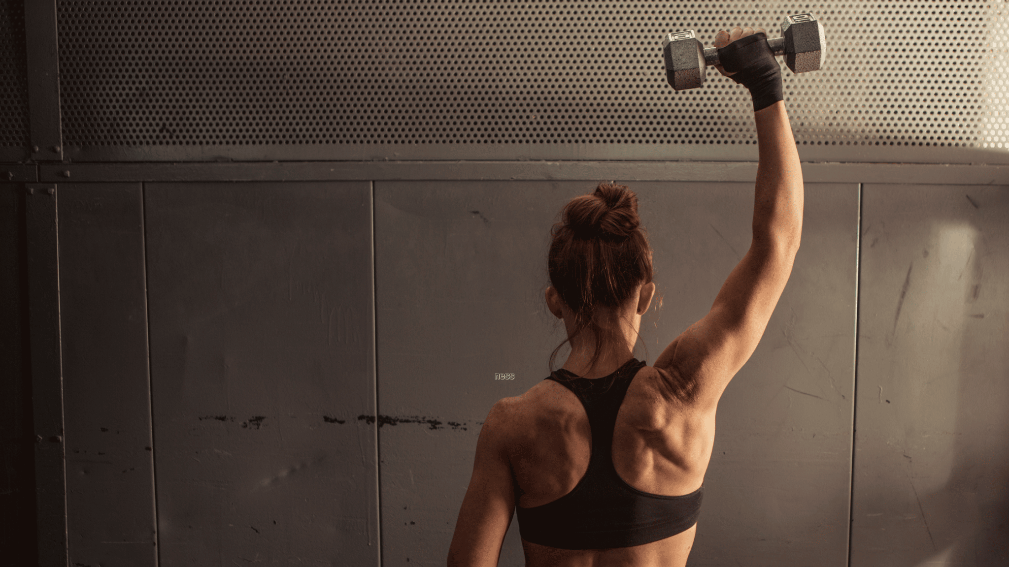woman lifting weight above her head