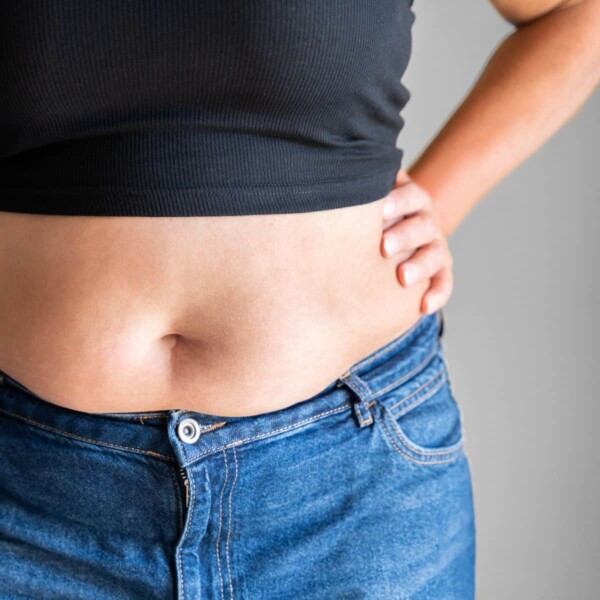 woman wearing jeans showing bell with muffin talk