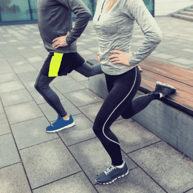 man and woman outside doing a one leg lunge