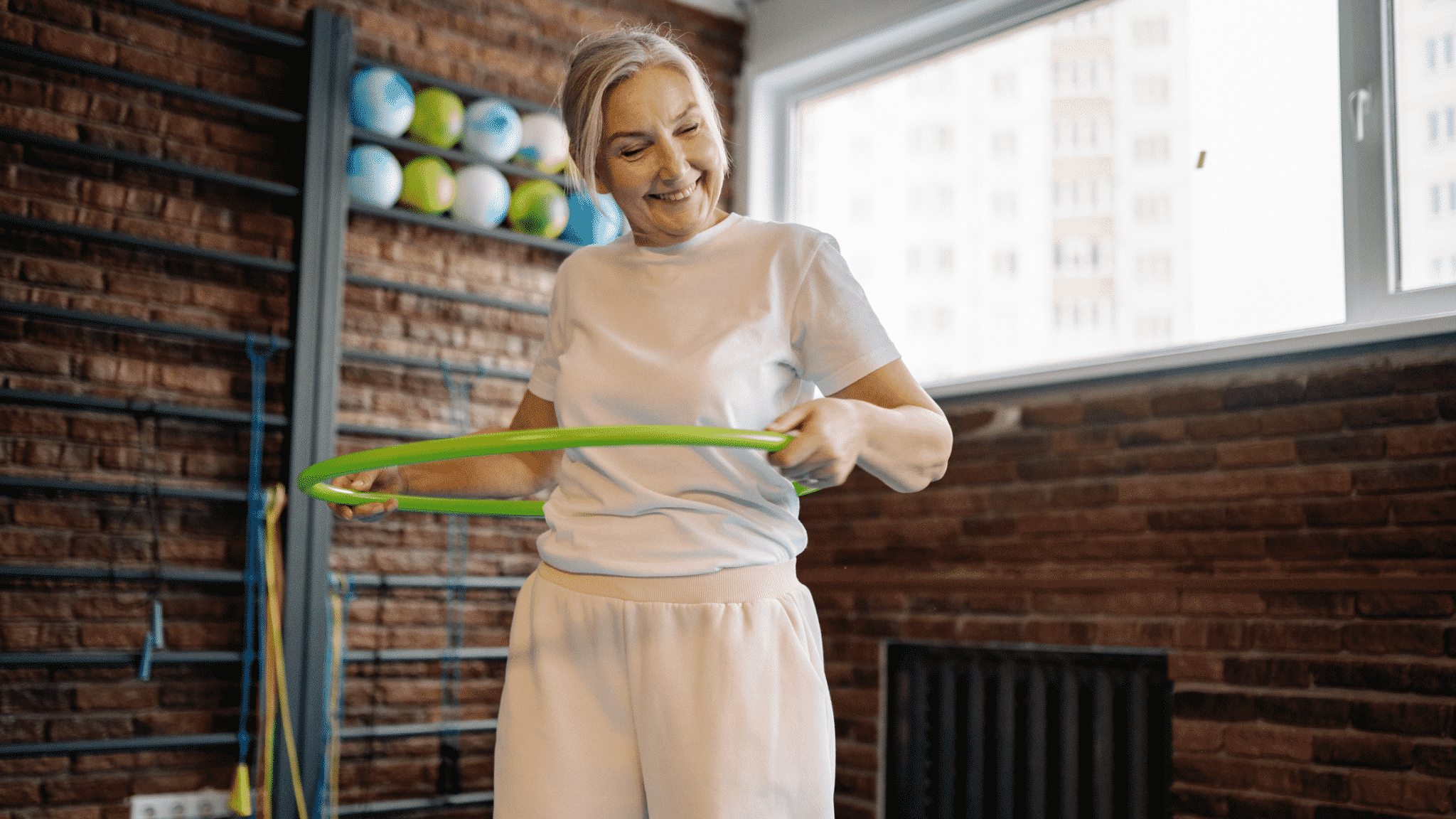 older woman with green hula hoop
