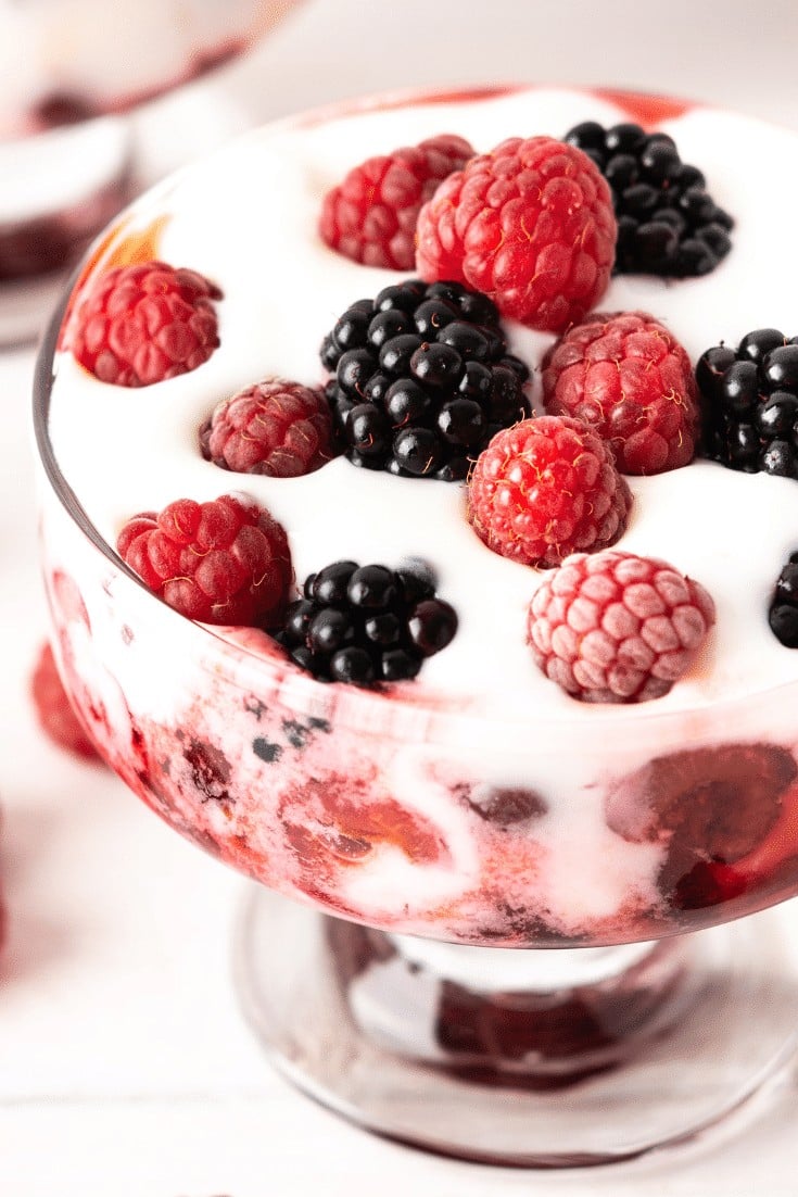 Glass bowl with coconut cream and mixed berries