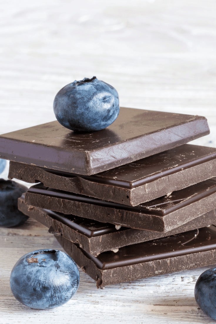 Squares of dark chocolate and blueberries