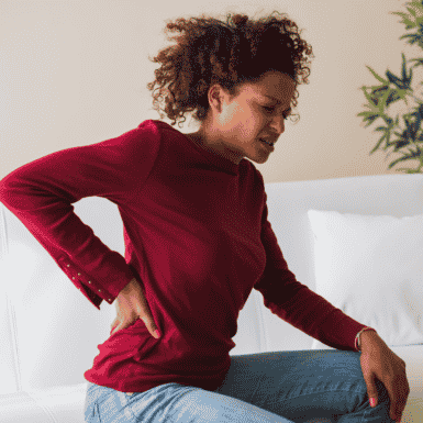 Woman holding back experiencing SI joint pain
