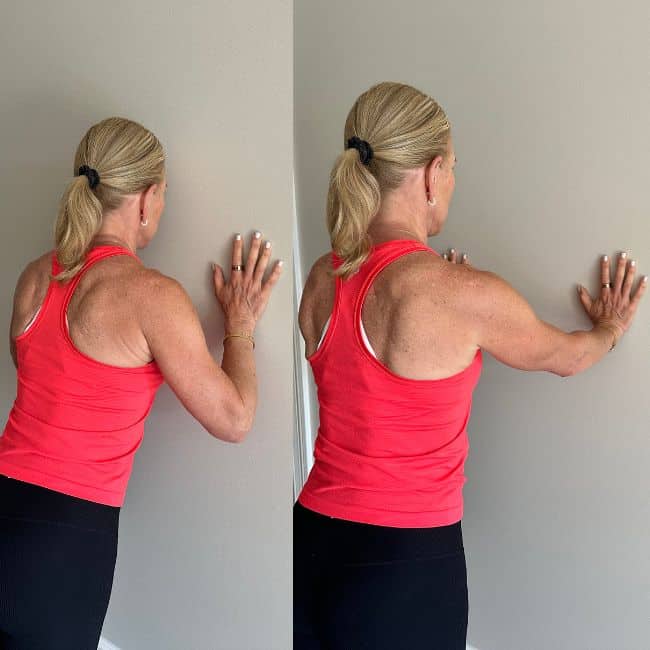 woman demonstrating wall push up modification exercise