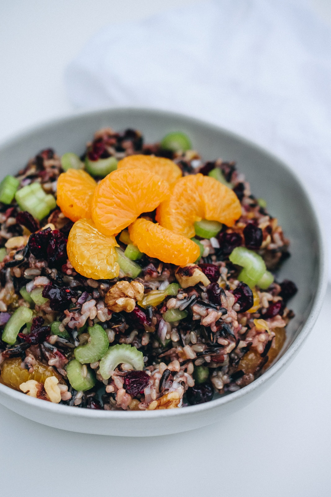 45 degree view of wild rice salad in a white bowl