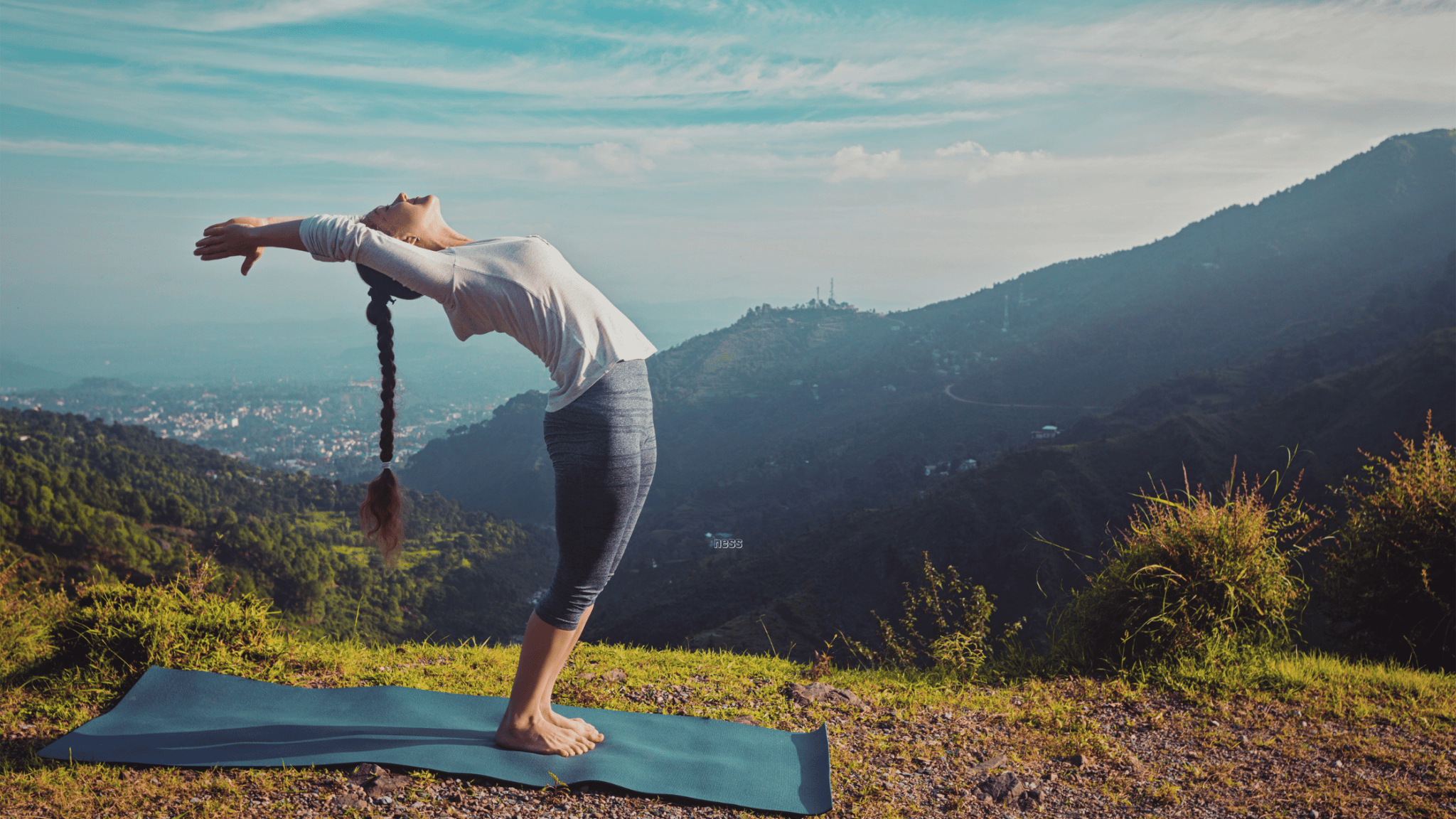 woman doing yoga on a mountain